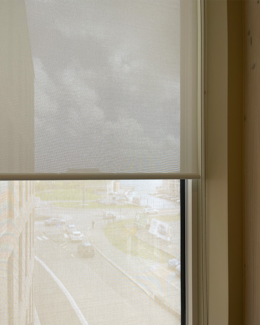 Detaljbilde av vindu med rullegardin Screen Vision 5% fra Mermet i fargen White Linen. Foto. Detaljbilde av vindu med rullegardin Screen Vision 5% fra Mermet i fargen White Linen. Foto.